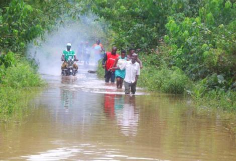 A photo of people wading through floodwater